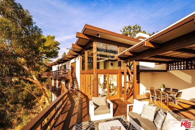 wooden terrace with outdoor lounge area