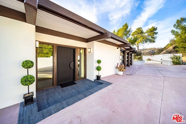 doorway to property featuring a patio