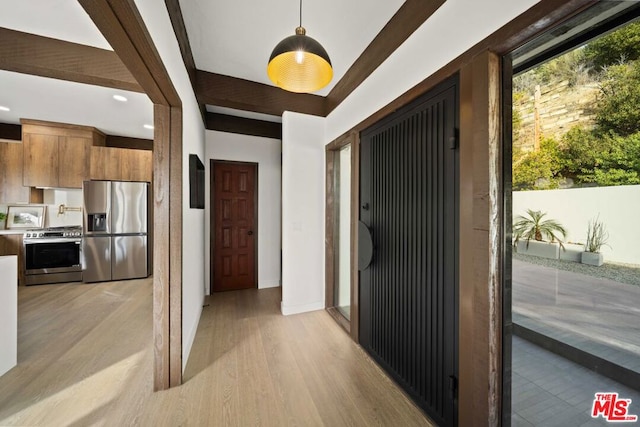 corridor with light hardwood / wood-style flooring