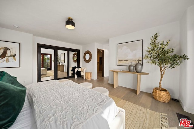 bedroom with light hardwood / wood-style floors and access to outside