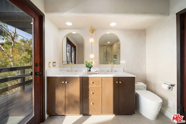 bathroom featuring tile patterned floors, vanity, and toilet