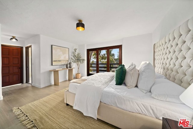 bedroom with light wood-type flooring and access to exterior