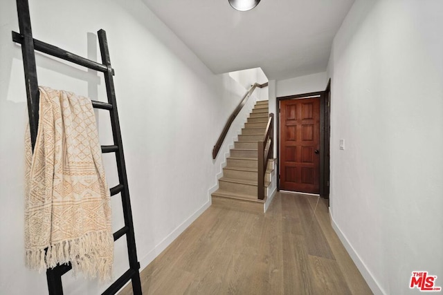 stairs with wood-type flooring