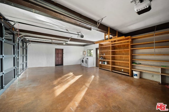 garage with a garage door opener and independent washer and dryer