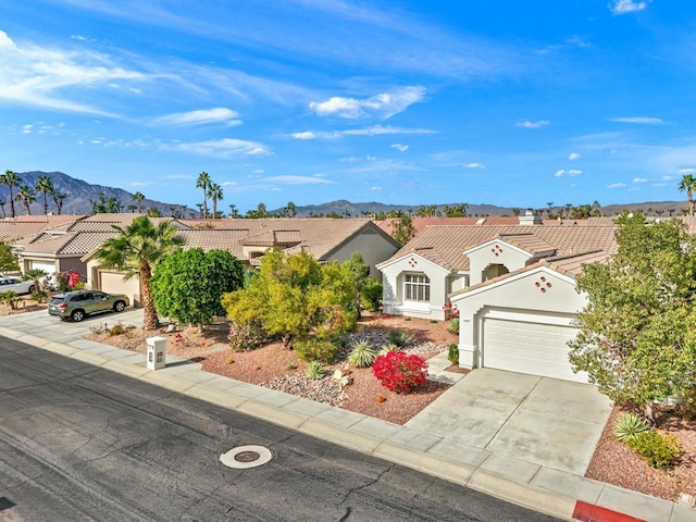 view of front of home featuring a mountain view and a garage