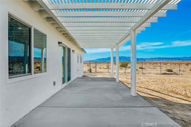 view of patio / terrace featuring a mountain view and a pergola