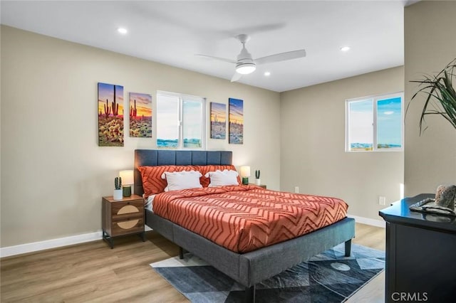 bedroom featuring ceiling fan and light hardwood / wood-style floors