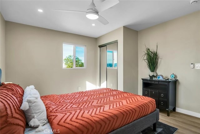 bedroom with hardwood / wood-style floors and ceiling fan