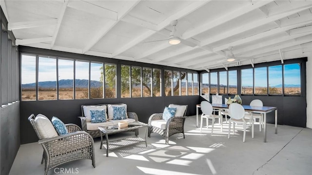 sunroom featuring a mountain view and ceiling fan