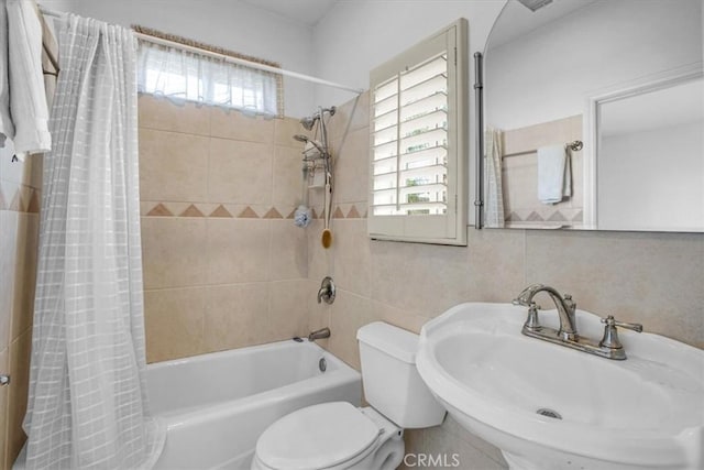 full bathroom with toilet, shower / bath combination with curtain, tile walls, and sink