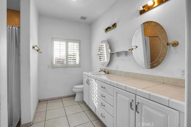 bathroom featuring tile patterned floors, toilet, vanity, and a shower with shower curtain