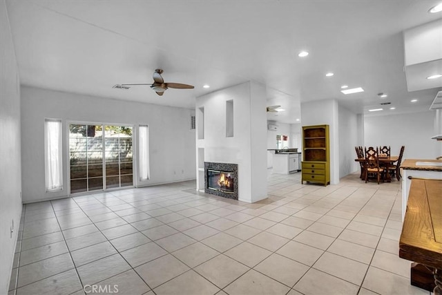 unfurnished living room featuring ceiling fan and light tile patterned floors