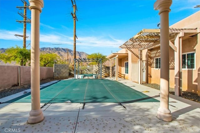 view of swimming pool featuring a pergola, a mountain view, and a patio