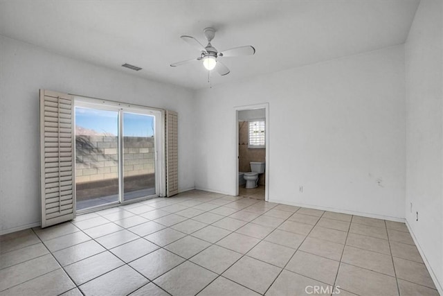 tiled spare room featuring ceiling fan and a wealth of natural light