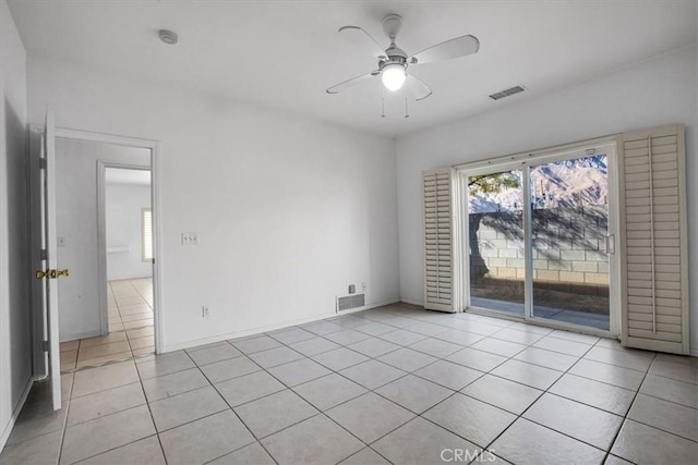 empty room featuring ceiling fan and light tile patterned floors