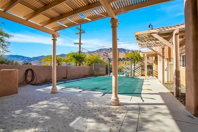 view of pool with a mountain view, a patio, and a pergola