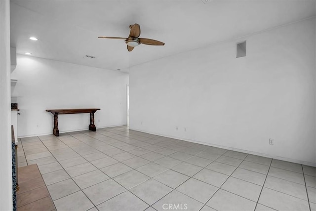 empty room with ceiling fan and light tile patterned floors