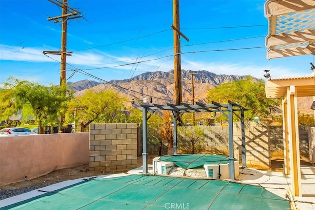 view of patio / terrace with a mountain view and a pergola