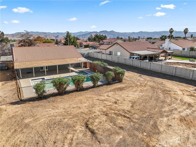 exterior space featuring a fenced in pool and a mountain view