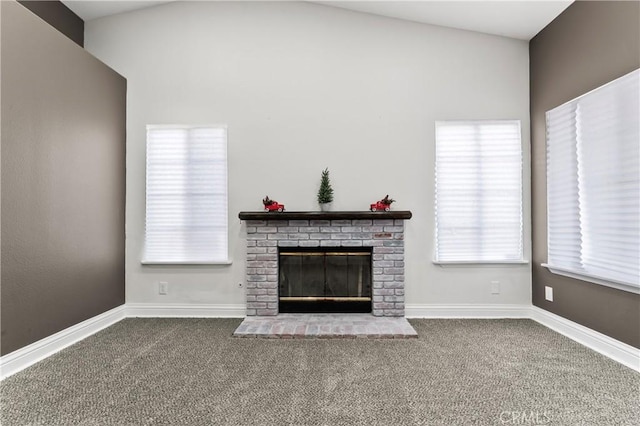 unfurnished living room featuring a brick fireplace and carpet floors