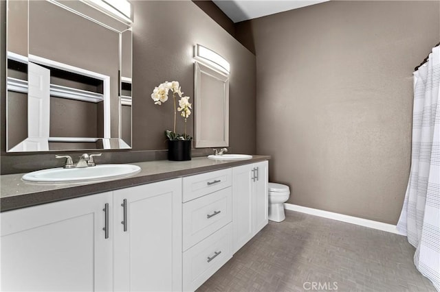 bathroom featuring toilet and vanity