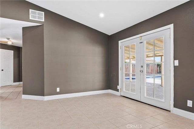 tiled empty room with french doors and vaulted ceiling