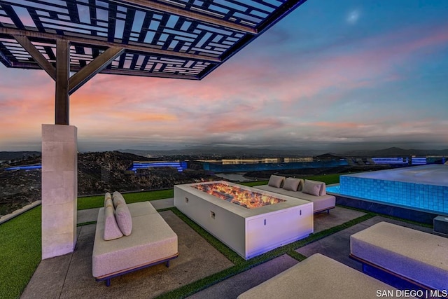 patio terrace at dusk with an outdoor fire pit