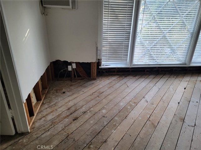 spare room with an AC wall unit