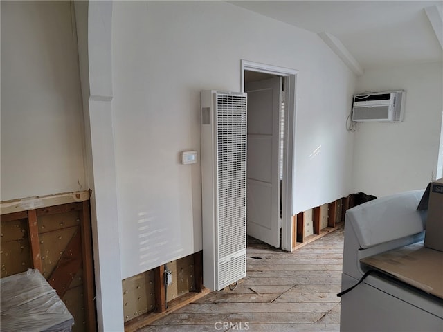 corridor featuring light wood-type flooring and a wall mounted air conditioner