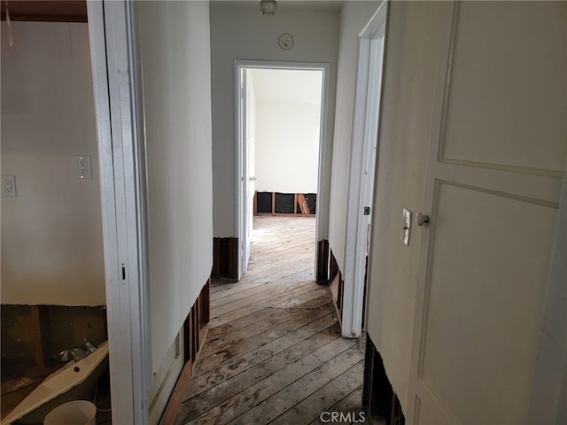 hall with hardwood / wood-style floors