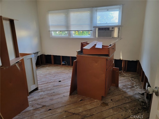 misc room featuring a healthy amount of sunlight, hardwood / wood-style flooring, and cooling unit