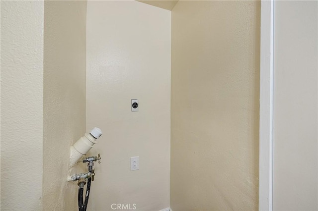 washroom with hookup for an electric dryer