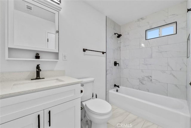 full bathroom featuring toilet, vanity, and tiled shower / bath