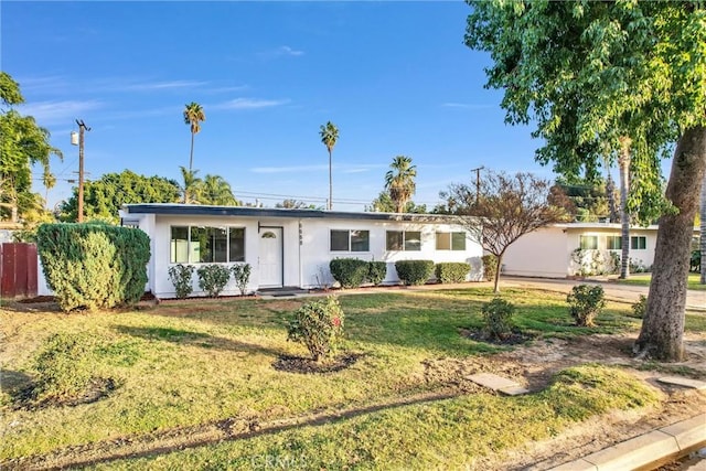 ranch-style house with a front lawn