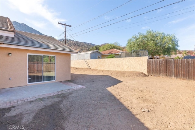 view of yard with a mountain view and a patio