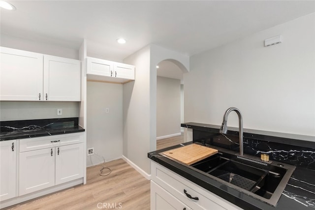 kitchen featuring light hardwood / wood-style floors, sink, and white cabinetry