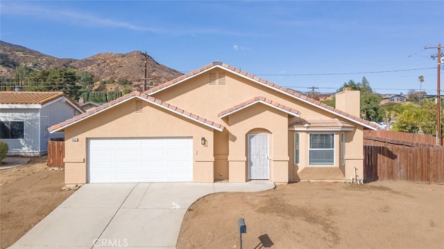 view of front of home featuring a mountain view and a garage