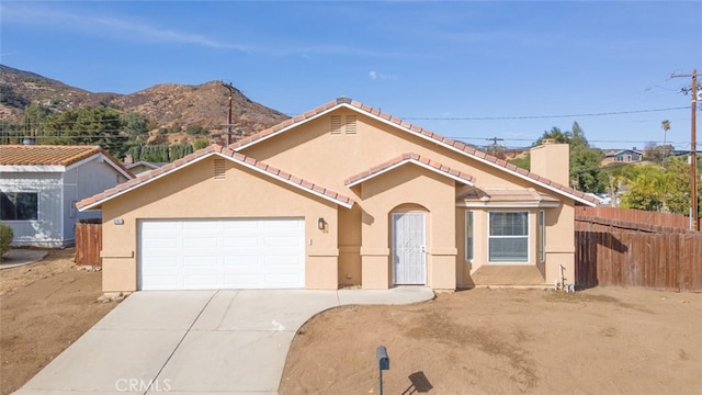 view of front facade featuring a mountain view and a garage