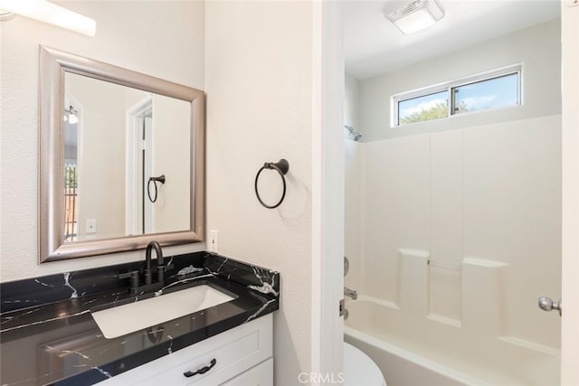 full bathroom with washtub / shower combination, vanity, and toilet