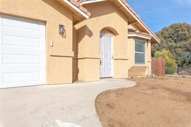 view of exterior entry with a garage