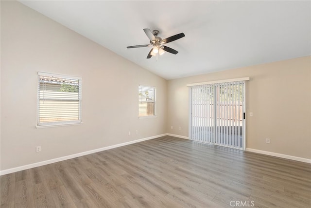 unfurnished room with ceiling fan, hardwood / wood-style floors, and vaulted ceiling