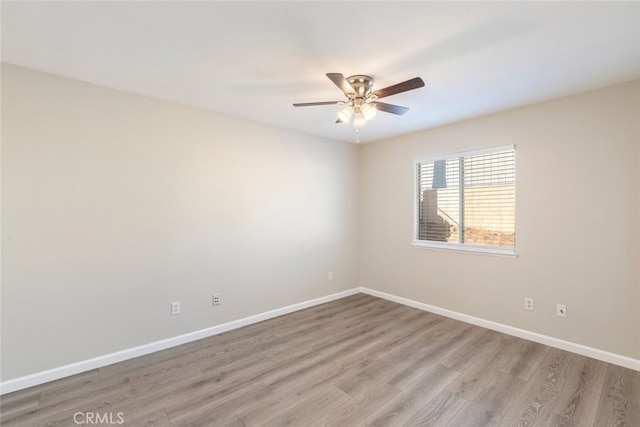 unfurnished room with ceiling fan and light wood-type flooring