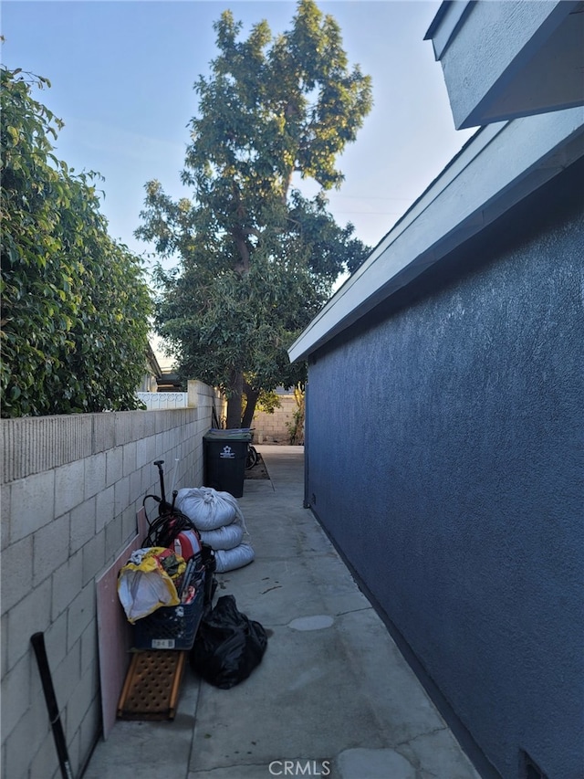 2214 Mark St, Santa Ana, CA 92703 - view of side of home featuring stucco siding, a patio, and fence