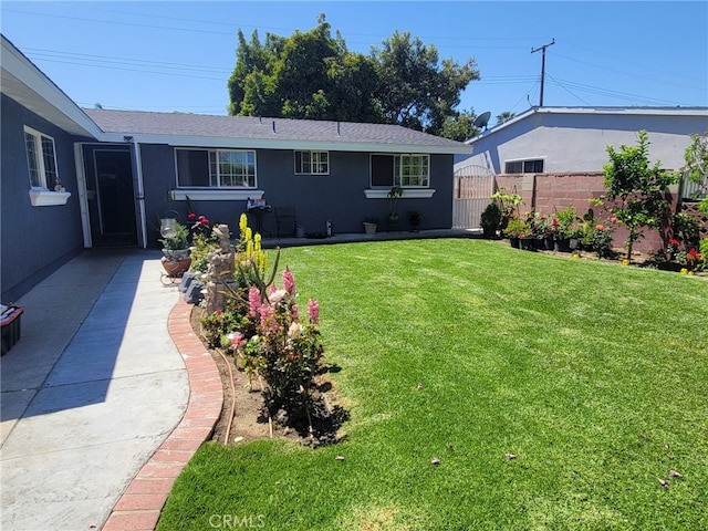 2214 Mark St, Santa Ana, CA 92703 - back of house with fence, roof with shingles, a yard, and stucco siding