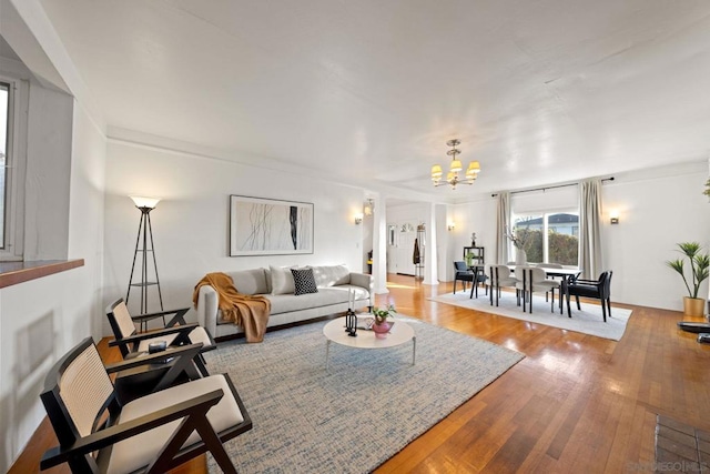 living room with a chandelier and hardwood / wood-style floors