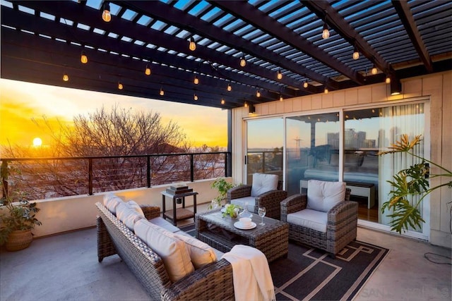 patio terrace at dusk with an outdoor hangout area and a pergola