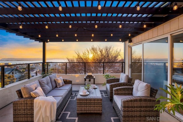 patio terrace at dusk with an outdoor hangout area and a pergola