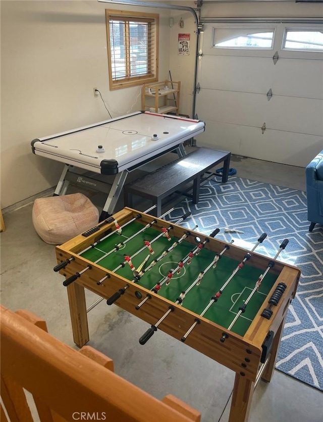 game room with concrete flooring