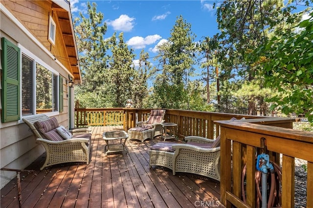 wooden terrace with an outdoor living space