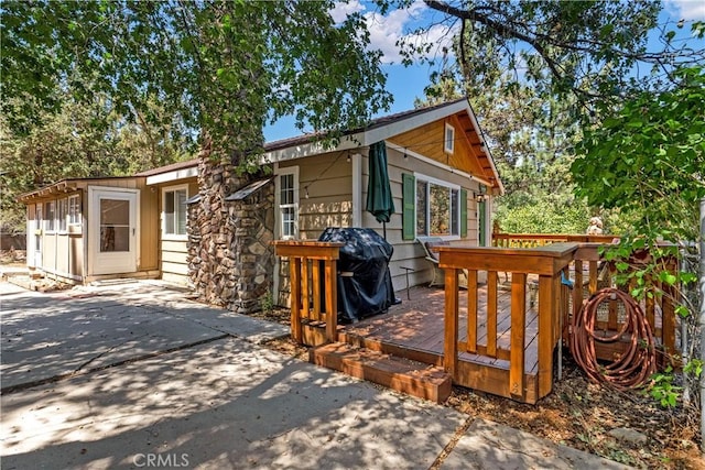 view of home's exterior featuring a deck and a patio area